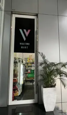 a door to a walk thru mart with a potted plant at Soho Suites, Centrally Located at KL City Centre in Kuala Lumpur