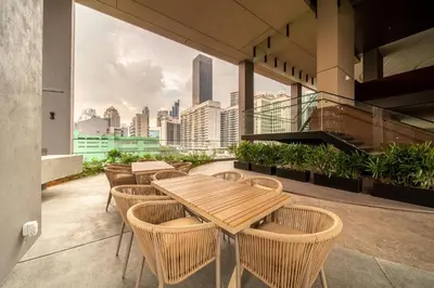 a patio with tables and chairs and a view of the city at Axon Residence Bukit Bintang Kuala Lumpur By Apex in Kuala Lumpur
