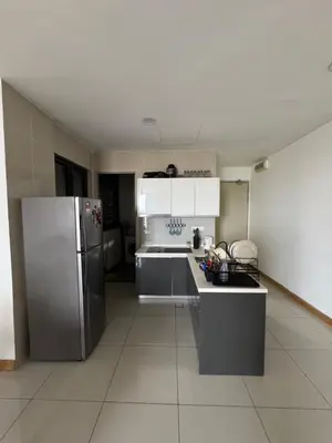 a kitchen with a stainless steel refrigerator and white cabinets at Queen Room At KL Gateway Residence LRT Linked in Kuala Lumpur