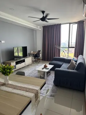 a living room with two blue couches and a tv at Queen Room At KL Gateway Residence LRT Linked in Kuala Lumpur