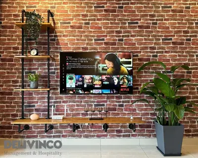 a wall with a tv on a brick wall at Trion - 2BR - 6pax - KL - 9mins - IKEA & Velocity in Kuala Lumpur