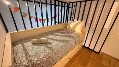 a bed in a crib with a hat on it at KL Sentral, Est Bangsar#11, 7Pax in Kuala Lumpur