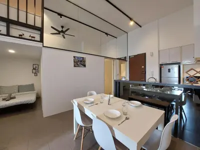 a dining room and kitchen with a white table and chairs at KL Sentral, Est Bangsar#11, 7Pax in Kuala Lumpur