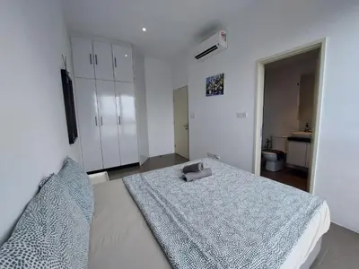 a bedroom with a large bed and a bathroom at KL Sentral, Est Bangsar#11, 7Pax in Kuala Lumpur