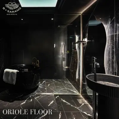 a black bathroom with a black tub and a sink at B Sarang Suite Hotel Kuala Lumpur in Kuala Lumpur