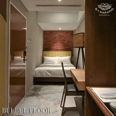 a small room with a bed and a table and a desk at B Sarang Suite Hotel Kuala Lumpur in Kuala Lumpur