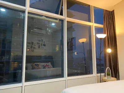 a bedroom with a window with a view of a city at sky suite klcc in Kuala Lumpur