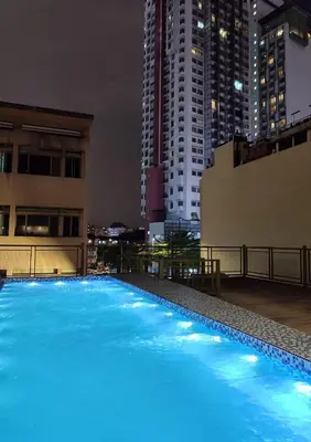 a large swimming pool on the roof of a building at night at Bestow Boutique Hotel in Kuala Lumpur