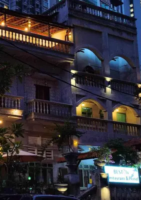 an old building with a balcony at night at Bestow Boutique Hotel in Kuala Lumpur
