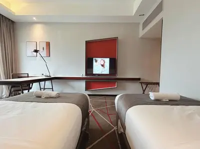 a hotel room with two beds and a flat screen tv at M101 KLCC KL city King Suites by Livin in Kuala Lumpur