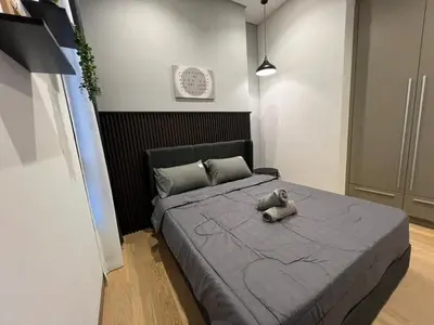 a teddy bear sitting on a bed in a bedroom at Lucentia Residence At Kuala Lumpur By Dreamcloud in Kuala Lumpur