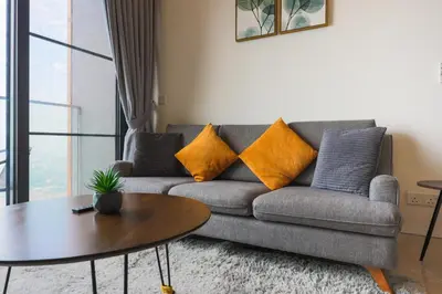 a living room with a couch and a table at Lucentia Residence At Kuala Lumpur By Dreamcloud in Kuala Lumpur