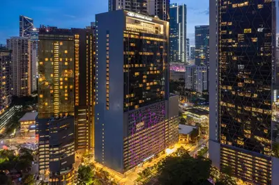 a city skyline at night with tall buildings at Crowne Plaza Kuala Lumpur City Centre by IHG in Kuala Lumpur