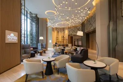 a lobby with chairs and tables and a chandelier at Crowne Plaza Kuala Lumpur City Centre by IHG in Kuala Lumpur