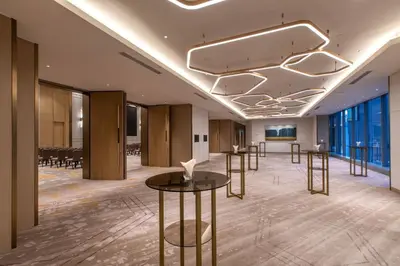 a meeting room with tables and chairs in a building at Crowne Plaza Kuala Lumpur City Centre by IHG in Kuala Lumpur