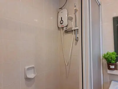 a shower with a hair dryer in a bathroom at SCC Gateway Chinatown Hotel in Kuala Lumpur