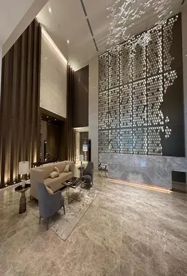 a lobby with a couch and chairs in a building at Quill Residence KLCC in Kuala Lumpur