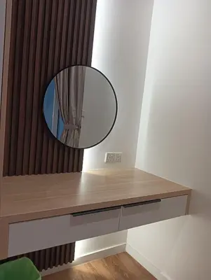 a dressing table with a mirror on the wall at Quill Residence KLCC in Kuala Lumpur