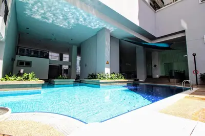 a swimming pool in the middle of a building at Electus Suite in Kuala Lumpur