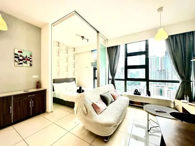 a room with a bed and a chair and a bedroom at Robertson Bukit Bintang with Netflix,TRX,KLCC in Kuala Lumpur