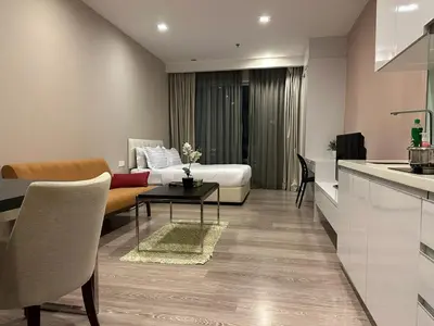 a kitchen and a living room with a bed and a table at One Bukit ceylon @ Bukit Bintang City Centre in Kuala Lumpur