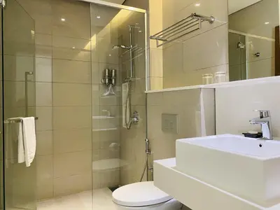 a bathroom with a toilet and a sink and a shower at Tribeca Serviced Hotel by Millennium in Kuala Lumpur