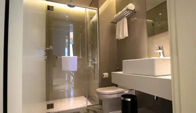 a bathroom with a sink and a toilet and a shower at Tribeca Serviced Hotel by Millennium in Kuala Lumpur