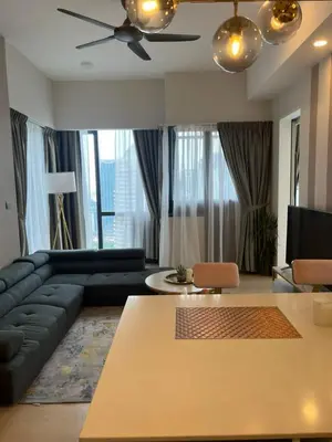 a living room with a couch and a table at Klcc suites at star - 2 bedroom in Kuala Lumpur