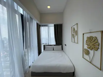 a bed in a room with a large window at Klcc suites at star - 2 bedroom in Kuala Lumpur