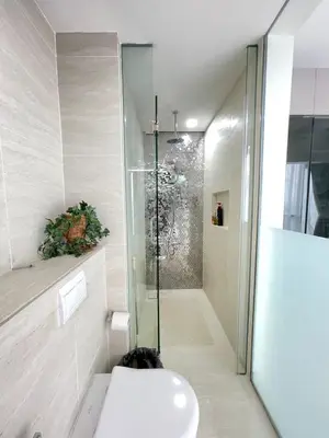 a bathroom with a glass shower and a toilet at Klcc suites at star - 2 bedroom in Kuala Lumpur