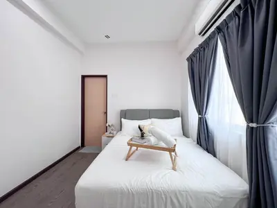 a bedroom with a bed with a table on it at MH Maison by Manhattan Group in Kuala Lumpur