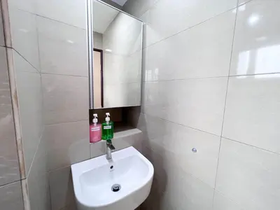a white bathroom with a sink and a mirror at MH Maison by Manhattan Group in Kuala Lumpur