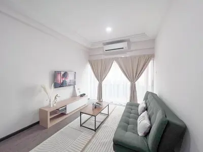 a living room with a green couch and a table at MH Maison by Manhattan Group in Kuala Lumpur