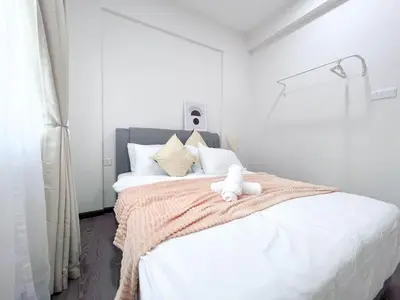 a bedroom with a bed with a teddy bear on it at MH Maison by Manhattan Group in Kuala Lumpur