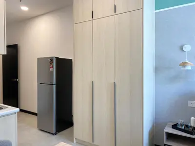 a kitchen with a refrigerator next to a wall at Neu Suite by JS Home in Kuala Lumpur