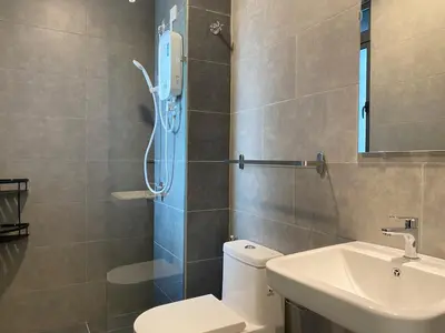 a bathroom with a shower and a toilet and a sink at Neu Suite by JS Home in Kuala Lumpur