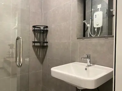 a bathroom with a sink and a mirror at Neu Suite by JS Home in Kuala Lumpur