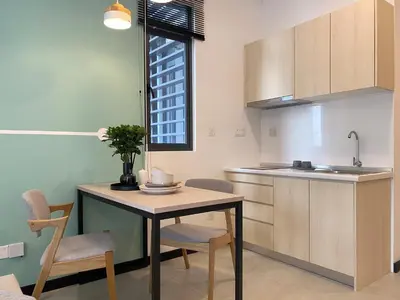 a kitchen with a table and chairs and a sink at Neu Suite by JS Home in Kuala Lumpur