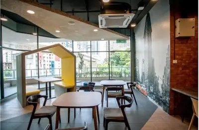 a restaurant with tables and chairs and a large window at Neu Suite by JS Home in Kuala Lumpur