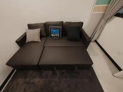 a black couch with two pillows on it in a room at Neu Suites by JS Home in Kuala Lumpur