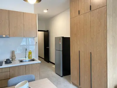 a kitchen with a black refrigerator and a sink at Neu Suites by JS Home in Kuala Lumpur
