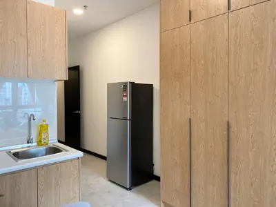 a kitchen with a stainless steel refrigerator next to a sink at Neu Suites by JS Home in Kuala Lumpur
