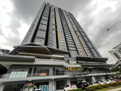 a tall building with cars parked in front of it at Neu Suites by JS Home in Kuala Lumpur