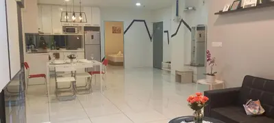 a living room with a couch and a kitchen at COZY TWO BEDROOM APARTMENT AT MERCU SUMMER in Kuala Lumpur