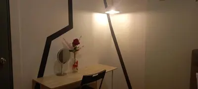 a table with a mirror and a vase with flowers at COZY TWO BEDROOM APARTMENT AT MERCU SUMMER in Kuala Lumpur