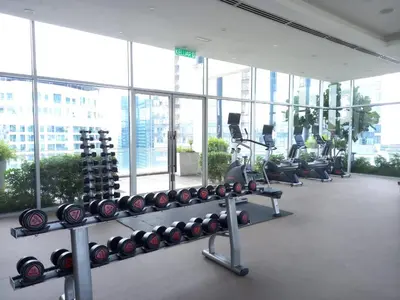 a gym with a lot of treadmills and weights at COZY TWO BEDROOM APARTMENT AT MERCU SUMMER in Kuala Lumpur