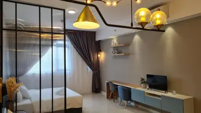 a bedroom with a bed and a desk with a computer at Chambers Service Suites KLCC By Cozy Stay in Kuala Lumpur