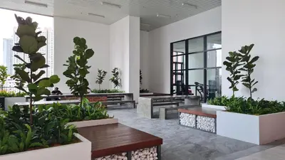 a lobby with benches and potted plants at Chambers Service Suites KLCC By Cozy Stay in Kuala Lumpur