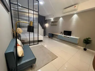 a living room with a couch and a bed and a television at Chambers Suites KL BY Fortune in Kuala Lumpur