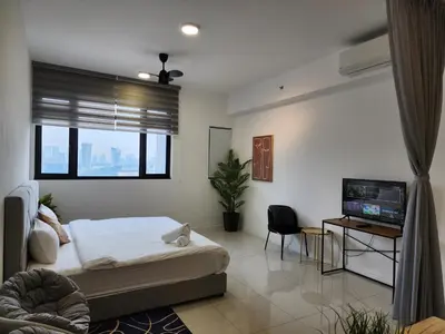 a bedroom with a bed and a flat screen tv at Chambers Suites KL BY Fortune in Kuala Lumpur